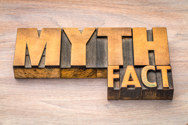 myth and fact word abstract in letterpress wood type printing blocks against grained wood